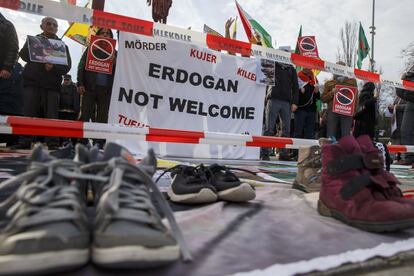 Un grupo de manifestantes sostienen pancartas contra el presidente de Turquía, Erdogan, durante una manifestación en la Place des Nations durante el Foro Global de Refugiados del Alto Comisionado de las Naciones Unidas en Ginebra (Suiza).