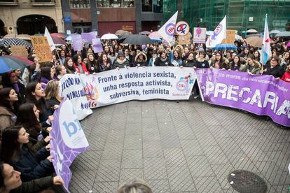 Women in Peregrina Square in Pontevedra holding up various banners.