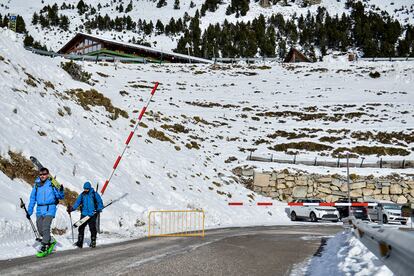 Dos excursionistas traspasan este sábado la barrera que da acceso a la estacion y pistas de esquí de Vallter 2000 (Girona).