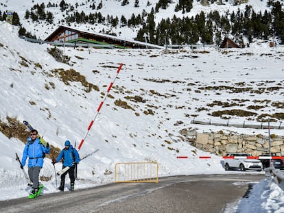 Dos excursionistas traspasan la barrera que da acceso a la estación de Vallter 2000 (Girona).