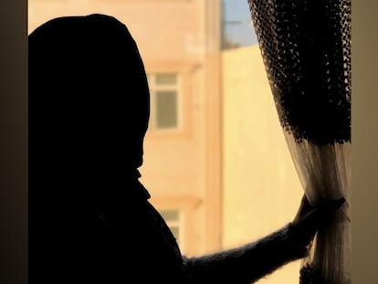 Noor looks out the window of her home in Herat, Afghanistan, in 2024. Photo courtesy of her family.