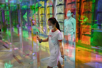 Una joven entra en una tienda de un centro comercial de Pekín (China).