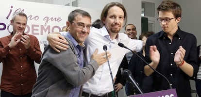 Pablo Iglesias (center) embraces party co-founder Juan Carlos Monedero after learning the results of the European elections in Spain.