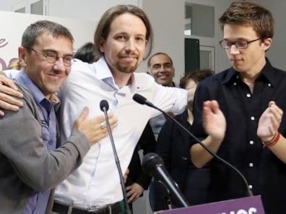 Pablo Iglesias (center) embraces party co-founder Juan Carlos Monedero after learning the results of the European elections in Spain.