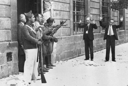 Soldiers loyal to Franco stop two passersby in a Seville street at the outset of the Civil War.