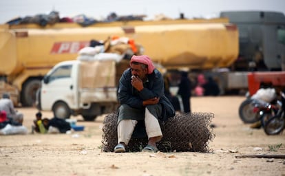 A displaced Syrians, who fled the countryside surrounding the Islamic State (IS) group stronghold of Raqa, smokes a cigarette at a temporary camp in the village of Ain Issa on April 28, 2017. / AFP PHOTO / DELIL SOULEIMAN