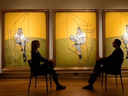 Visitors admire Francis Bacon’s ‘Three Studies of Lucian Freud’ at Christie’s in London.