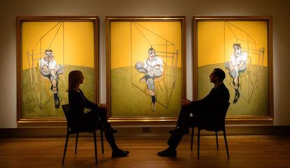 Visitors admire Francis Bacon’s ‘Three Studies of Lucian Freud’ at Christie’s in London.