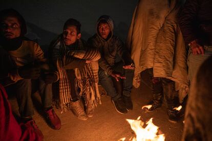 Migrantes venezolanos se calientan junto a una fogata improvisada a unos pasos del río Bravo, en Ciudad Juárez. 