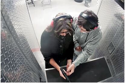 A still from the security video of the shooting range, in which Jennifer and Ethan Crumbley are seen testing the gun that the teen used to carry out the massacre.