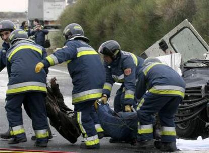 Un grupo de bomberos traslada el cuerpo de uno de los seis fallecidos tras el accidente ocurrido en Torquemada (Palencia).