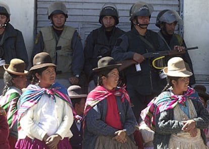 Varios policías vigilan a unas mujeres aimaras en la localidad de Ilave, unos 900 kilómetros al sureste de Lima.