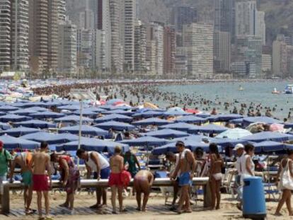 Tourists fill the beach in Benidorm this past summer.