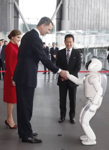 El rey Felipe y la reina Letizia saludan el robot Asimo de Honda.