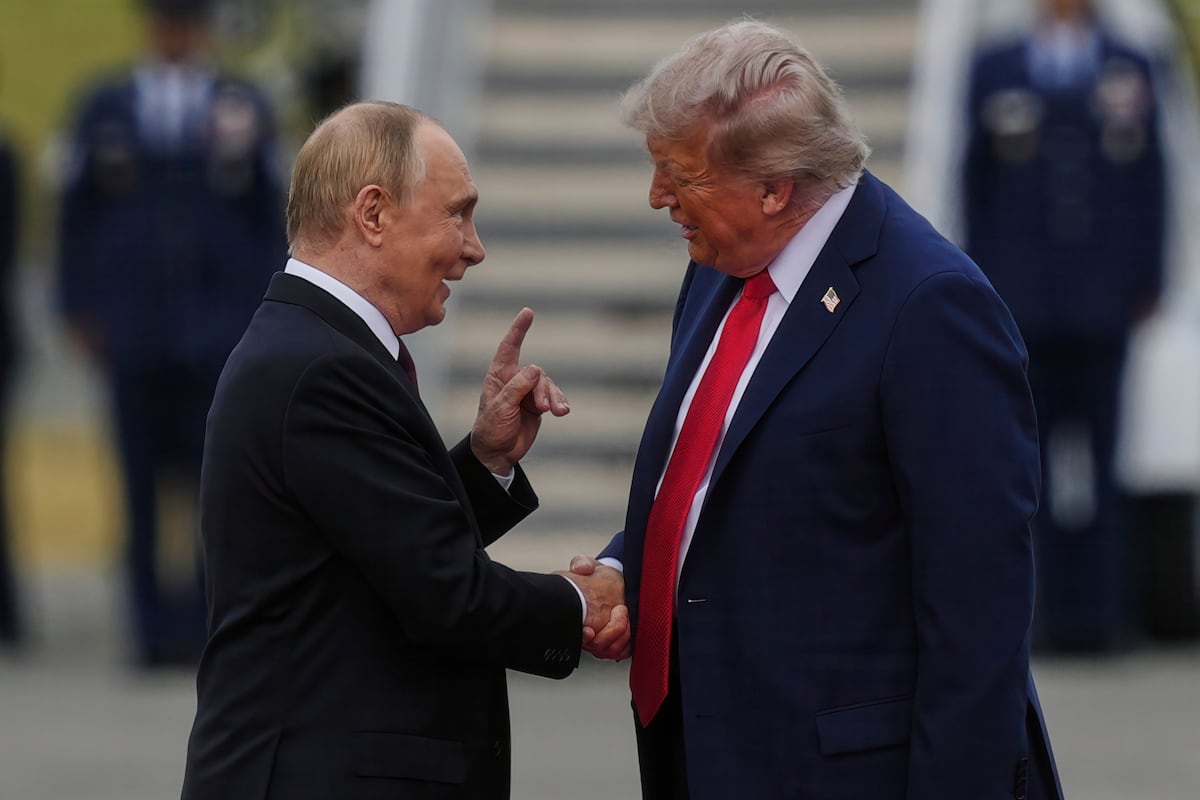 Trump Putin Alaska meeting handshake symbolizing betrayal of democracy and U.S. weakness
