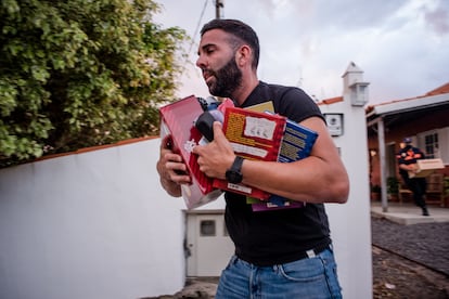 A man removes items from a house during the evacuation prompted by the volcano eruption. 