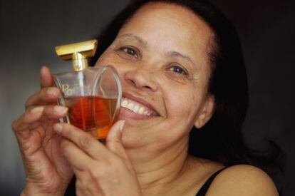 Isabel Sierra shows off her French perfume, the most expensive thing in her suitcase.