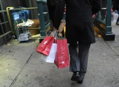 Un hombre sostiene bolsas con sus compras. EFE/Archivo