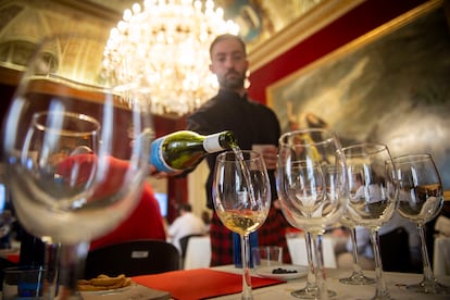 A waiter pours wine into one of the glasses on Tuesday.