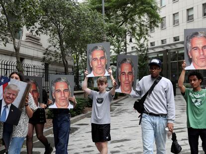 Los manifestantes sostienen carteles en alto protestando contra Jeffrey Epstein, mientras espera ser procesado en Nueva York por cargos de tráfico sexual de menores y tráfico sexual de menores, en julio de 2019.