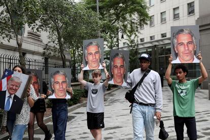 Los manifestantes sostienen carteles en alto protestando contra Jeffrey Epstein, mientras espera ser procesado en Nueva York por cargos de tráfico sexual de menores y tráfico sexual de menores, en julio de 2019.