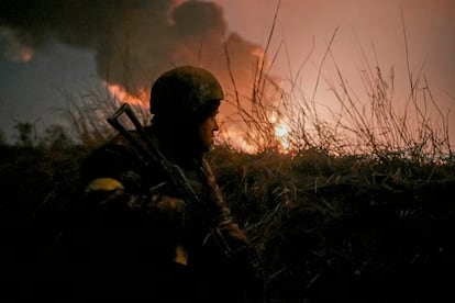 A Ukrainian soldier takes up a position near Vasilikiv airbase, near Kyiv