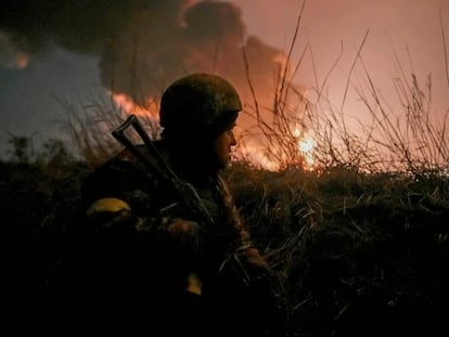 A Ukrainian soldier takes up a position near Vasilikiv airbase, near Kyiv