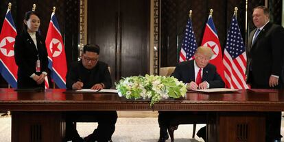 U.S. President Donald Trump and North Korea's leader Kim Jong Un sign documents that acknowledge the progress of the talks and pledge to keep momentum going, after their summit at the Capella Hotel on Sentosa island in Singapore June 12, 2018. As they are watched by Kim Yo Jong, sister of North Korean leader Kim Jong Un and U.S. Secretary of State Mike Pompeo. REUTERS/Jonathan Ernst