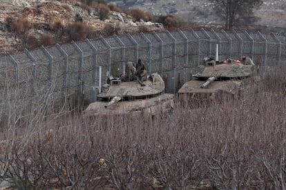 Israeli tanks at the security fence between Israel and Syria, near the village of Majdal Shams.