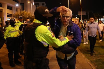 Roberto Canseco, head of Foreign Affairs and Political Affairs at the Mexican Embassy, struggles with police outside the embassy.
