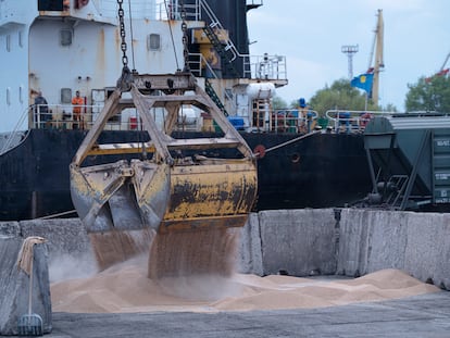 Workers load grain at a grain port in Izmail, Ukraine, on April 26, 2023.