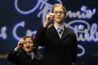 Schoolchildren sing out the prize-winning lottery number.