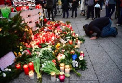 A Muslim man prays at a makeshift memorial for the attack victims on Tuesday.