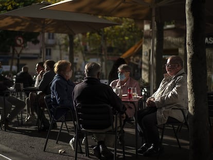 Patrons wear face masks at a sidewalk café in Barcelona on Wednesday.