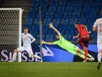 Switzerland's forward Haris Seferovic (R) kicks the ball in front of Spain's goalkeeper Unai Simon  during the UEFA Nations League football match between Switzerland and Spain at St. Jakob-Park stadium in Basel, on November 14, 2020. (Photo by Fabrice COFFRINI / AFP)