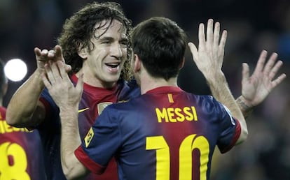 Puyol se abraza con Messi durante el partido ante el Zaragoza.