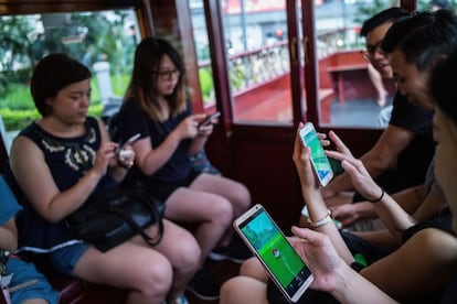 HONG KONG - JULY 30:  People join the Hong Kong&#039;s first Pokemon Go tram party on July 30, 2016 in Hong Kong, Hong Kong. Hundreds of youths attended the 18th Ani-Com and Games Hong Kong fair dressed as Japanese comic characters as the reality smartphone game Pokemon GO was launched in Hong Kong this week following the release of the app in Japan. Based on reports, shopping malls and local businesses in Hong Kong are offering Pokemon-related activities to draw in crowds that have flooded the streets to capture Pokemon while authorities aim to ban the game at public hospitals and schools after receiving complaints from the public.  (Photo by Lam Yik Fei/Getty Images)