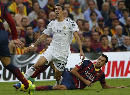 Sergio Busquets hace una entrada a Di María para intentar robar el balón.