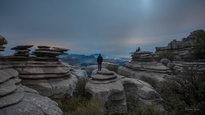 A magic place made with the erosion, rocks, and sky, and night lights, with human silhouette