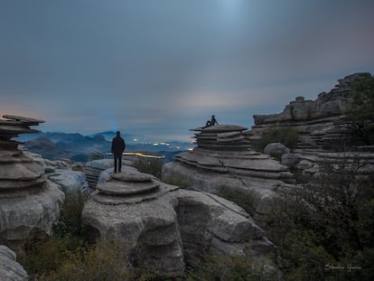 A magic place made with the erosion, rocks, and sky, and night lights, with human silhouette