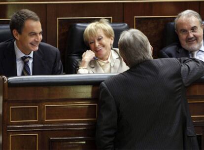 Rodríguez Zapatero, Fernández de la Vega y Solbes hablan con Sánchez Llibre (CiU), de espaldas, en el pleno del Congreso.