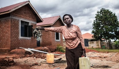 Betty Nakiberu, una de las cooperativistas, frente a su vivienda durante la construcción.