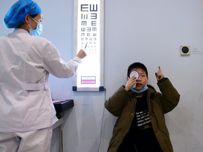 An ophthalmologist examines a child at a health center in Hefei, a city in eastern China.