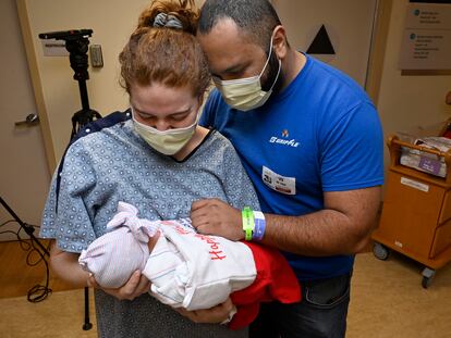 A couple holds their first child at a Long Beach hospital.