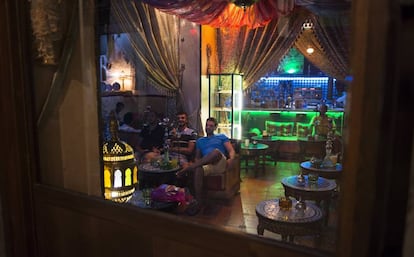 Patrons smoke a hookah in a bar in Granada, southern Spain.