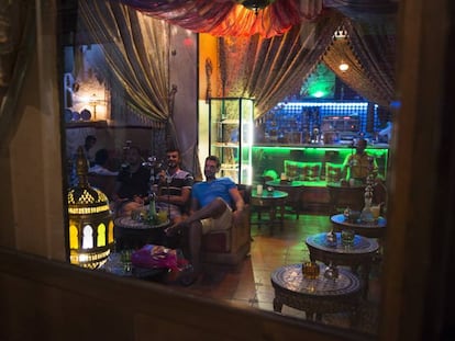 Patrons smoke a hookah in a bar in Granada, southern Spain.