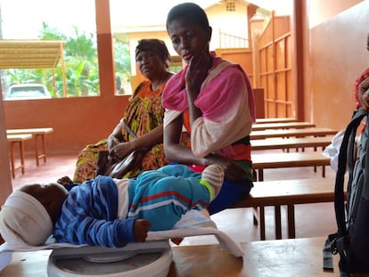 Un niño es pesado para comprobar su evolución en el dispensario de Obot (Camerún).