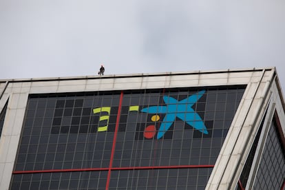 El logo de Caixabank tras la sustitución por el de Bankia en las torres Kio, en Madrid (España), a 27 de marzo de 2021.