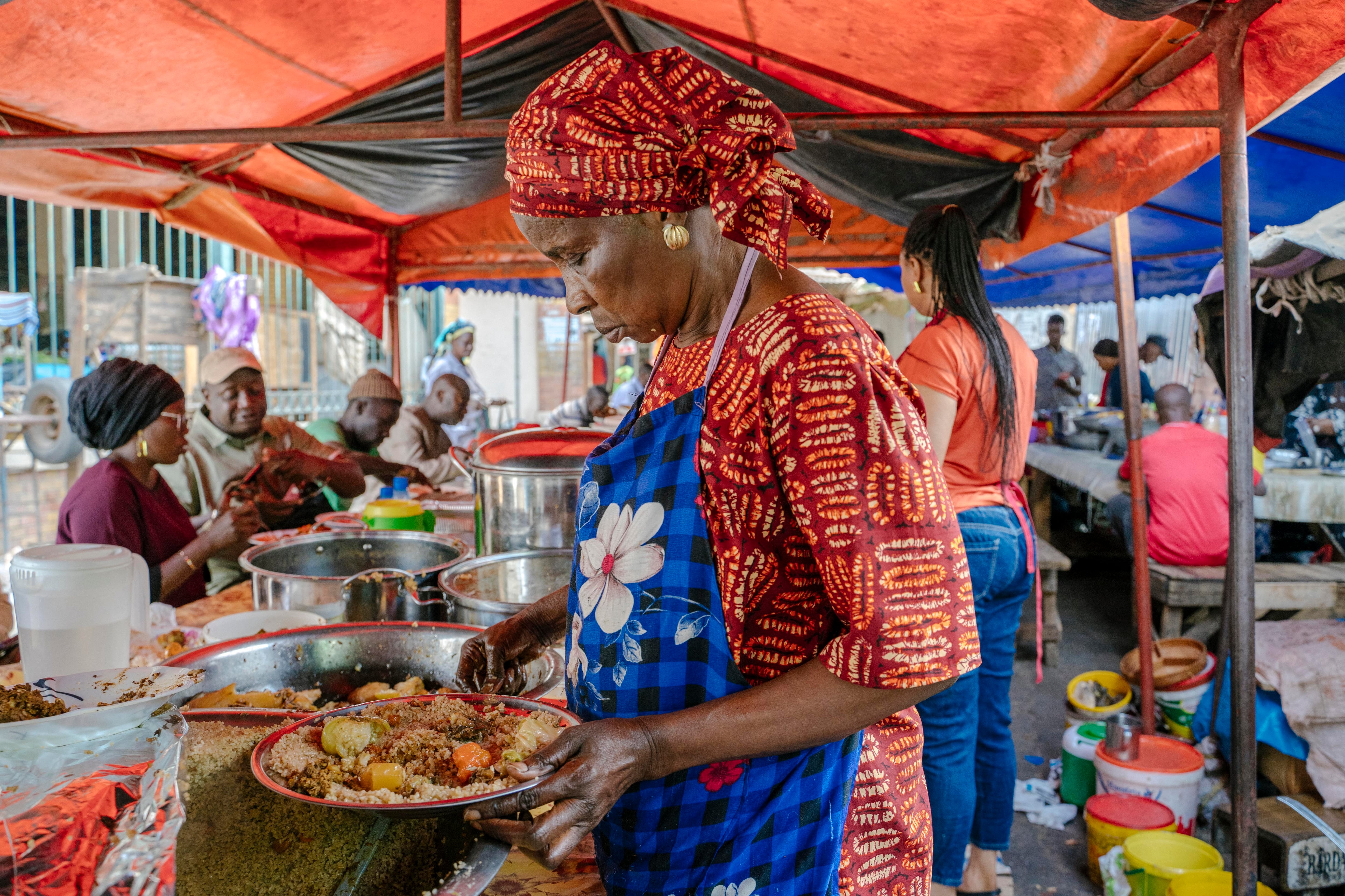 Una mujer sirve arroz con pescado en un mercado de Dakar (Senegal).
