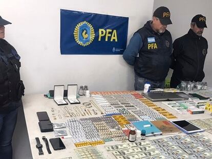 Police display money and other objects seized during the raid in Buenos Aires.